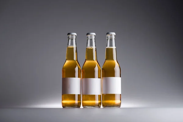 Three Glass Bottles Beer White Labels Row Dark Background — Stock Photo, Image