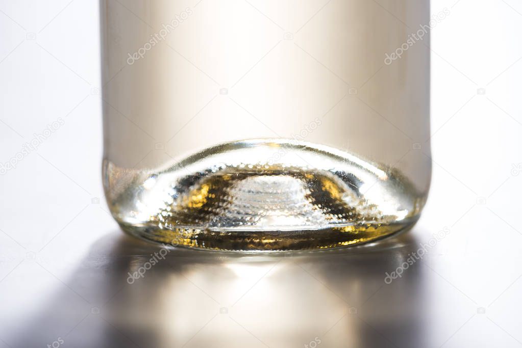 close up view of bottle of white wine on white background