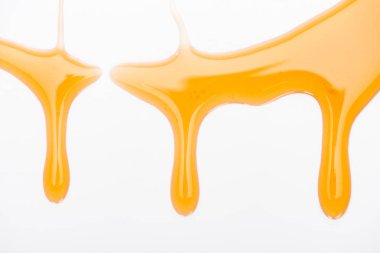 close up view of dripping sweet tasty honey isolated on white  clipart