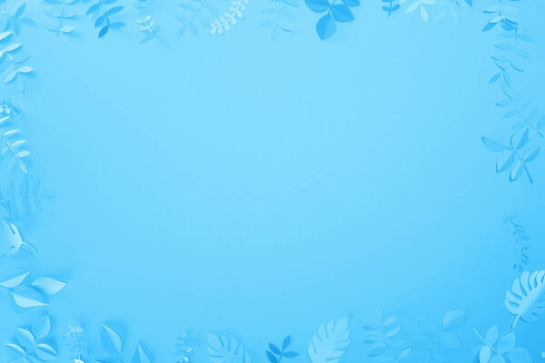 frame of paper cut leaves on blue minimalistic background with copy space