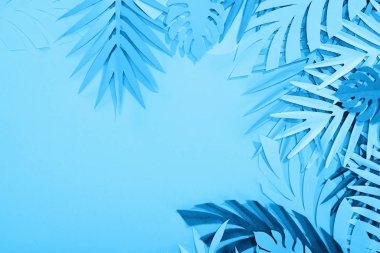 frame of paper leaves on blue minimalistic background with copy space clipart