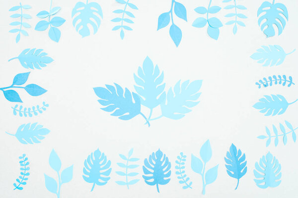 top view of blue paper cut  leaves isolated on white