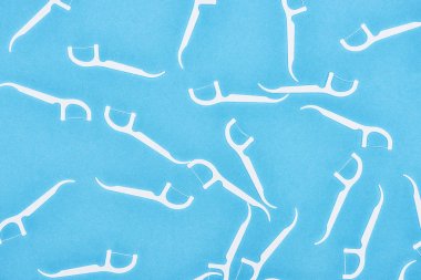 top view of white floss sticks isolated on blue  clipart