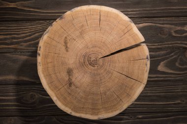 top view of wooden cutting board on brown table  clipart