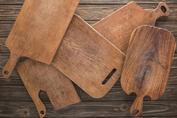 top view of wooden cutting boards on brown table 