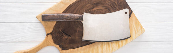 panoramic shot of wooden chopping board and meat chopper