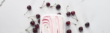 top view of delicious ice cream with cherries on marble grey background, panoramic shot clipart