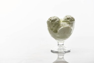 delicious pistachio ice cream in glass bowl isolated on white clipart