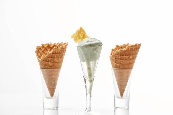 fresh crispy sweet waffle cones and pistachio ice cream isolated on white