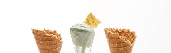 fresh crispy sweet waffle cones and pistachio ice cream isolated on white, panoramic shot