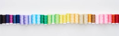 panoramic shot of bright and colorful threads on white background  clipart