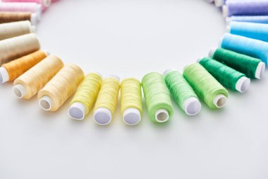 flat lay with bright and colorful threads on white background  clipart