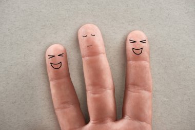 partial view of man showing three fingers symbolizing laughing abusers and sad victim on grey background clipart