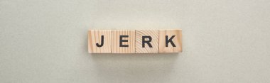 panoramic shot of wooden blocks with jerk lettering on grey background, bullying concept clipart