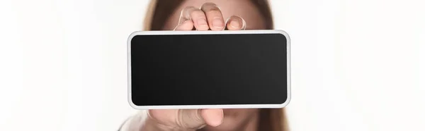 panoramic shot of victim of cyberbullying showing smartphone with blank screen isolated on white