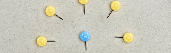 panoramic shot of pins symbolizing victim and abusers on grey background