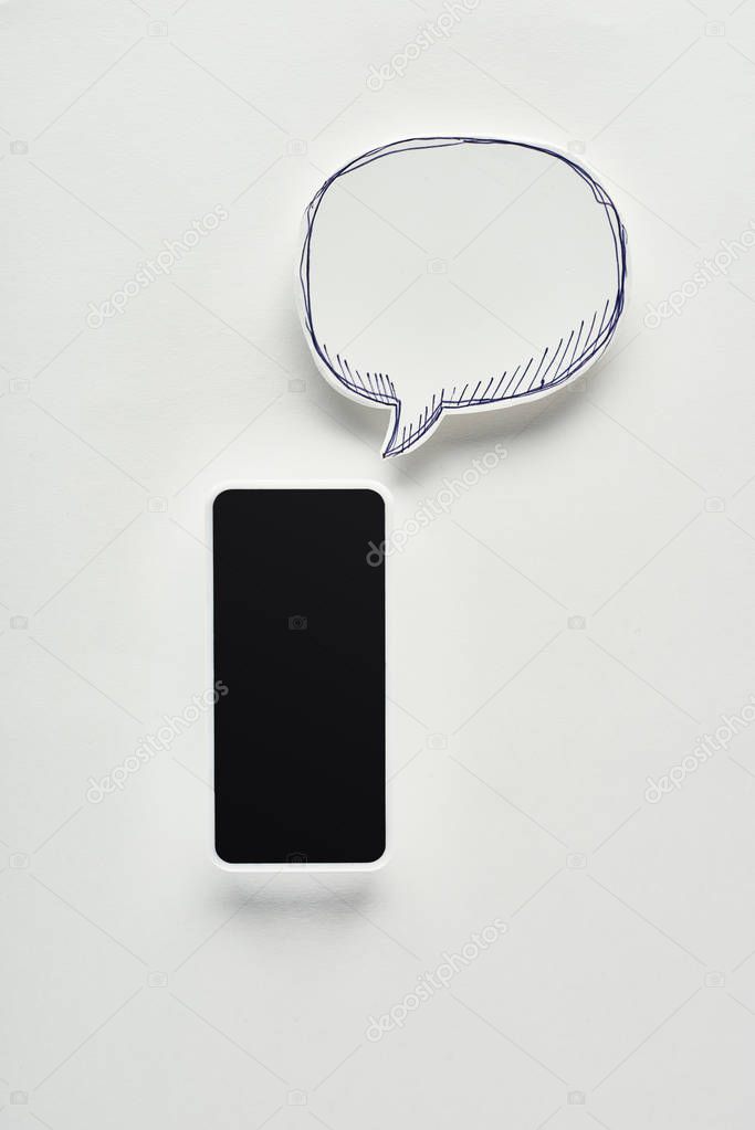 top view of smartphone with blank screen on white background near empty speech bubble, cyberbullying concept