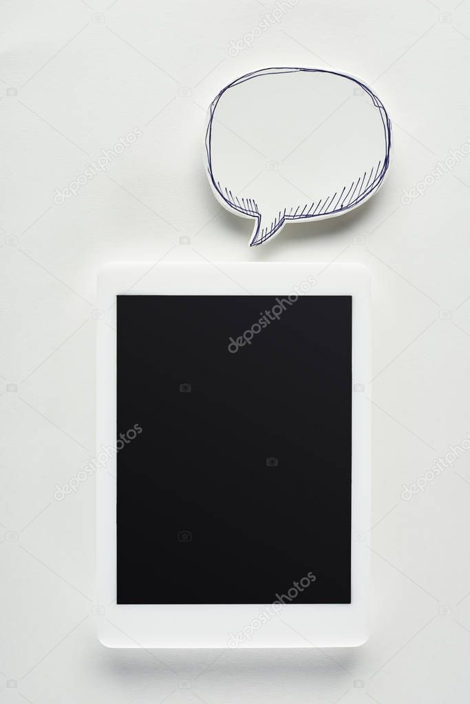 top view of digital tablet with blank screen on white background near speech bubble, cyberbullying concept