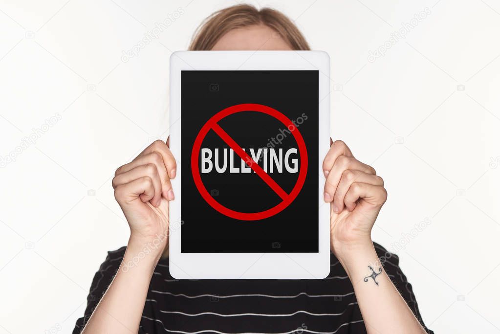 victim of cyberbullying showing digital tablet with stop bullying sing on screen isolated on white
