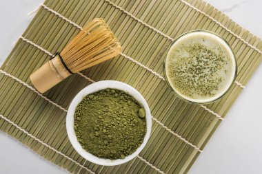 yeşil matcha çay tozu üst görünümü ve bambu mat cam içecek