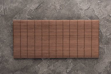 top view of bamboo mat on dark stone table clipart