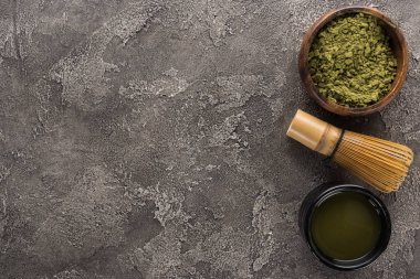 matcha yeşil çay üst görünümü ve koyu taş masada çırpma