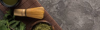 koyu taş masada bambu mat üzerinde geleneksel matcha yeşil çay üst görünümü