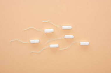 top view of white cotton tampons isolated on beige clipart