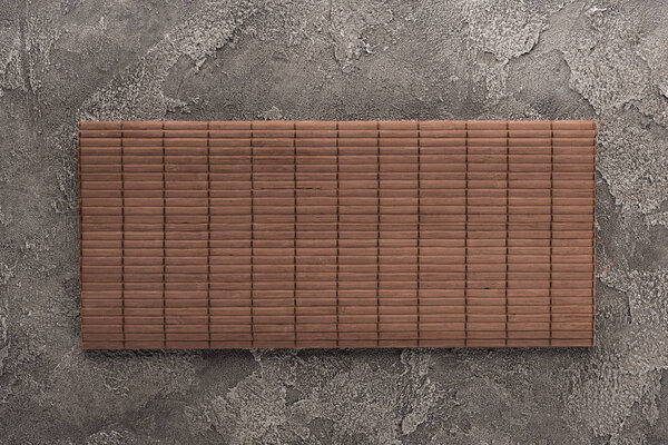 top view of bamboo mat on dark stone table