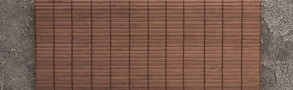 top view of bamboo mat on dark stone table