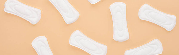seamless pattern white cotton sanitary napkins isolated on beige, panoramic shot