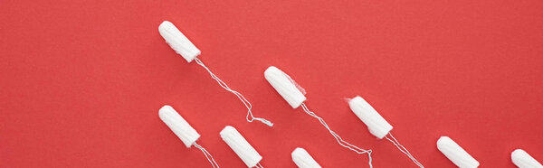 flat lay with white cotton tampons isolated on red, panoramic shot