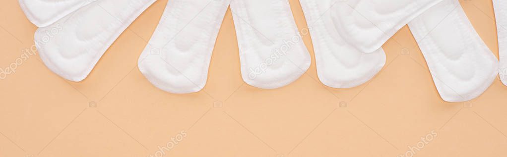 top view of white cotton sanitary towels isolated on beige, panoramic shot