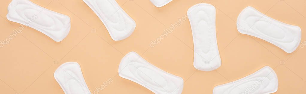 seamless pattern white cotton sanitary napkins isolated on beige, panoramic shot