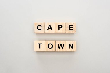 top view of wooden blocks with Cape Town lettering on white background clipart