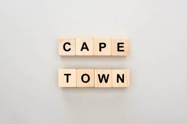 top view of wooden blocks with Cape Town lettering on white background clipart