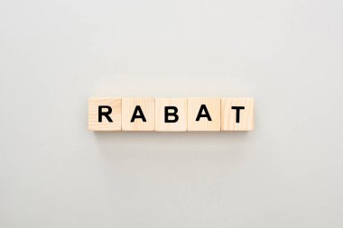 top view of wooden blocks with Rabat lettering on white background clipart