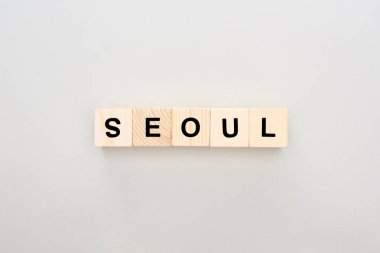 top view of wooden blocks with Seoul lettering on white background clipart
