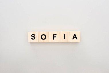 top view of wooden blocks with Sofia lettering on white background clipart