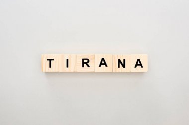 top view of wooden blocks with Tirana lettering on white background clipart