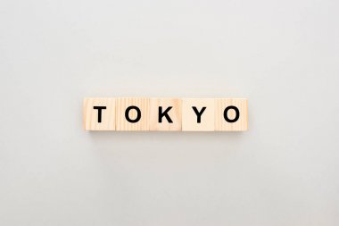 top view of wooden blocks with Tokyo lettering on white background clipart