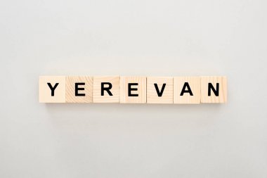 top view of wooden blocks with Yerevan lettering on white background clipart