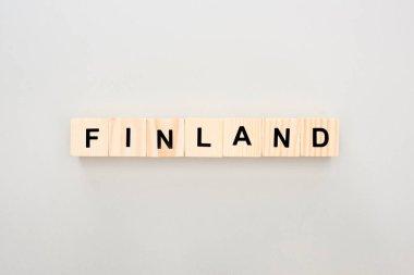 top view of wooden blocks with Finland lettering on white background clipart