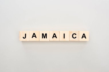 top view of wooden blocks with Jamaica lettering on white background clipart