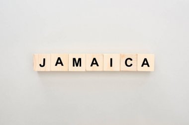 top view of wooden blocks with Jamaica lettering on white background clipart