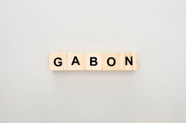 top view of wooden blocks with Gabon lettering on white background clipart