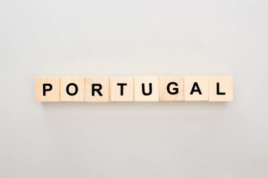 top view of wooden blocks with Portugal lettering on white background clipart