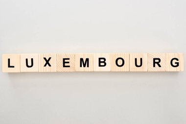 top view of wooden blocks with Luxembourg lettering on white background clipart