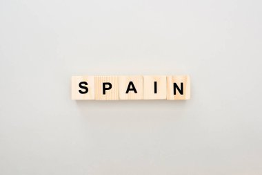 top view of wooden blocks with Spain lettering on white background clipart