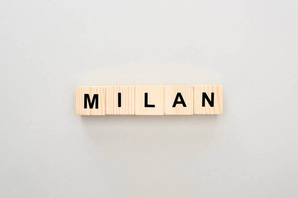 top view of wooden blocks with Milan lettering on white background